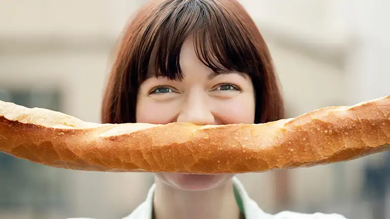 A French lady with a bread mustache